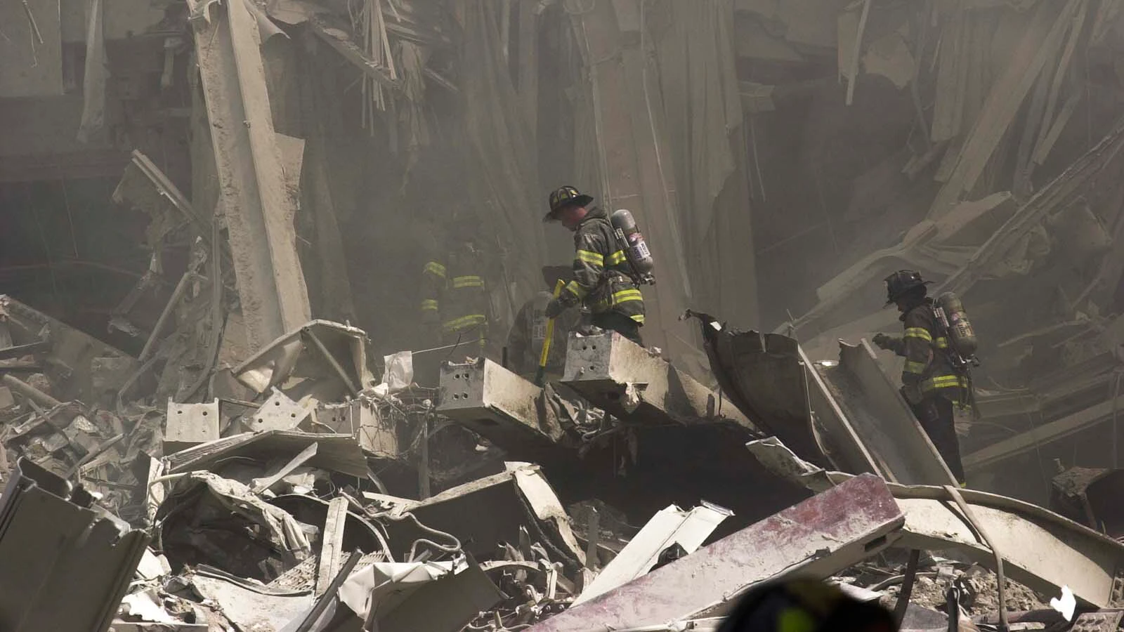 New York City firefighters look for survivors after the collapse of the World Trade Center on Sept. 11, 2001, in New York. Michael Hingson, who is blind, and his guide dog Rosalie survived.