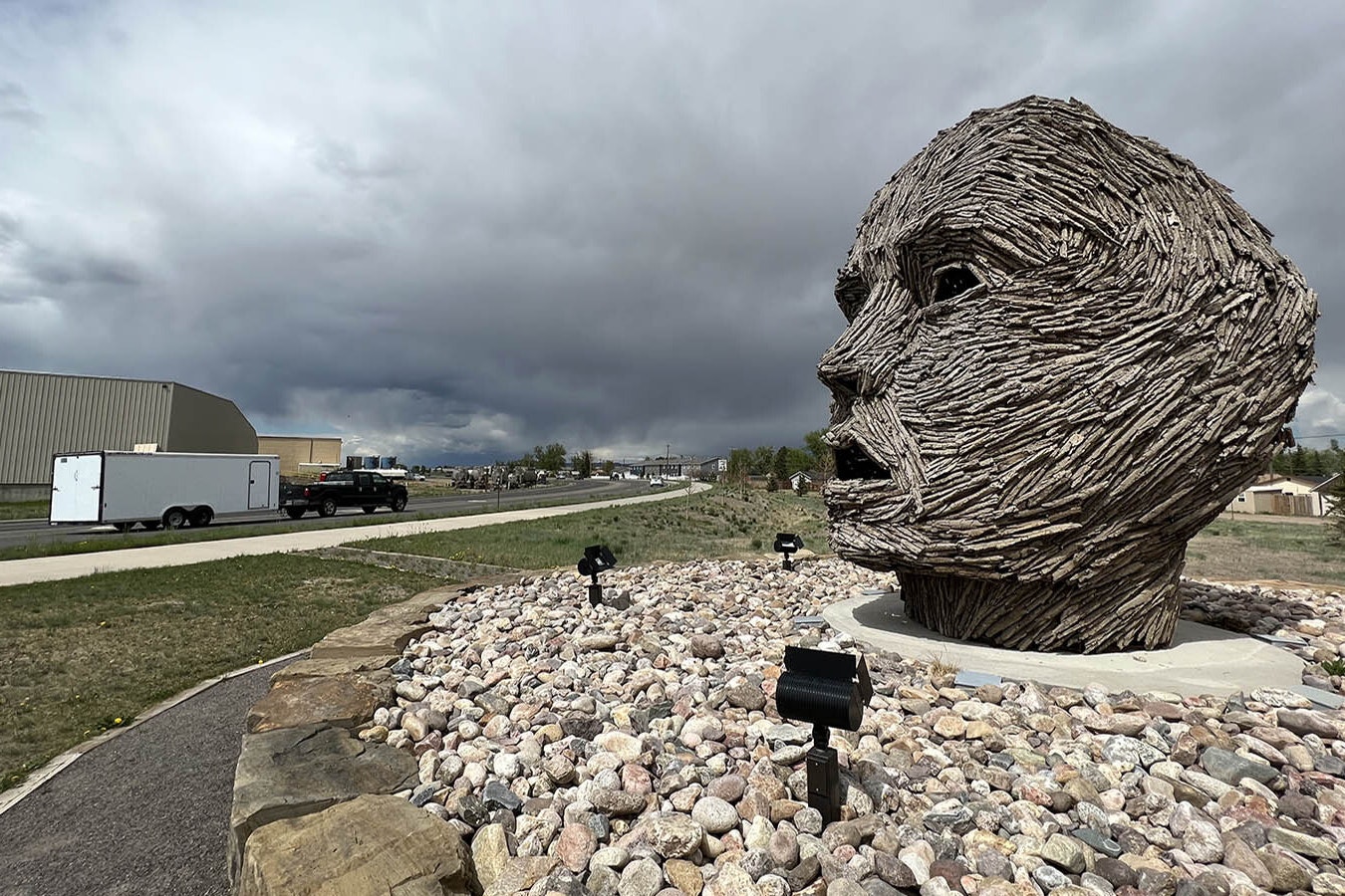 This giant head in West Laramie, Wyoming, has been looking out over Snowy Range Road since 2021. It's titled "Exhaling Dissolution" and is part of a rotating public art display.