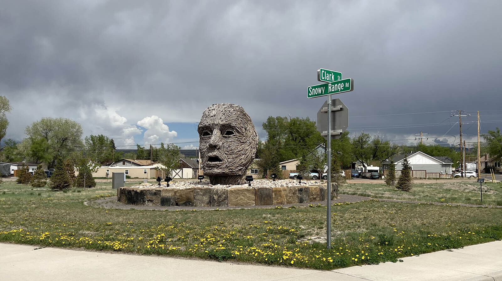 "Exhaling Dissolution" is a 13.5-foot-tall head made of cottonwood bark over steak rods and wire mesh. It looks west from the northeast corner of Clark Street and Snowy Range Road in Laramie.