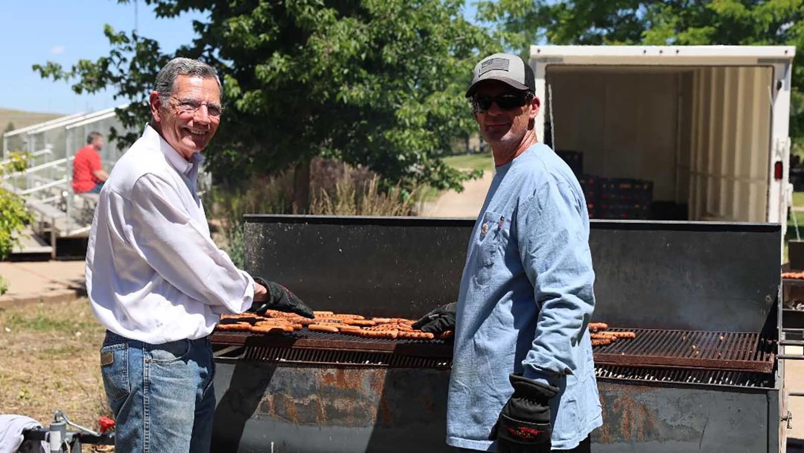 U.S. Sen. John Barrasso takes a turn grilling up thousands of hot dogs, served free at Gillette's Fourth of July bash.