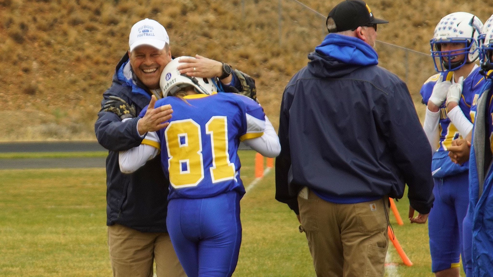 Coach Trembly shares a hug with Grove.