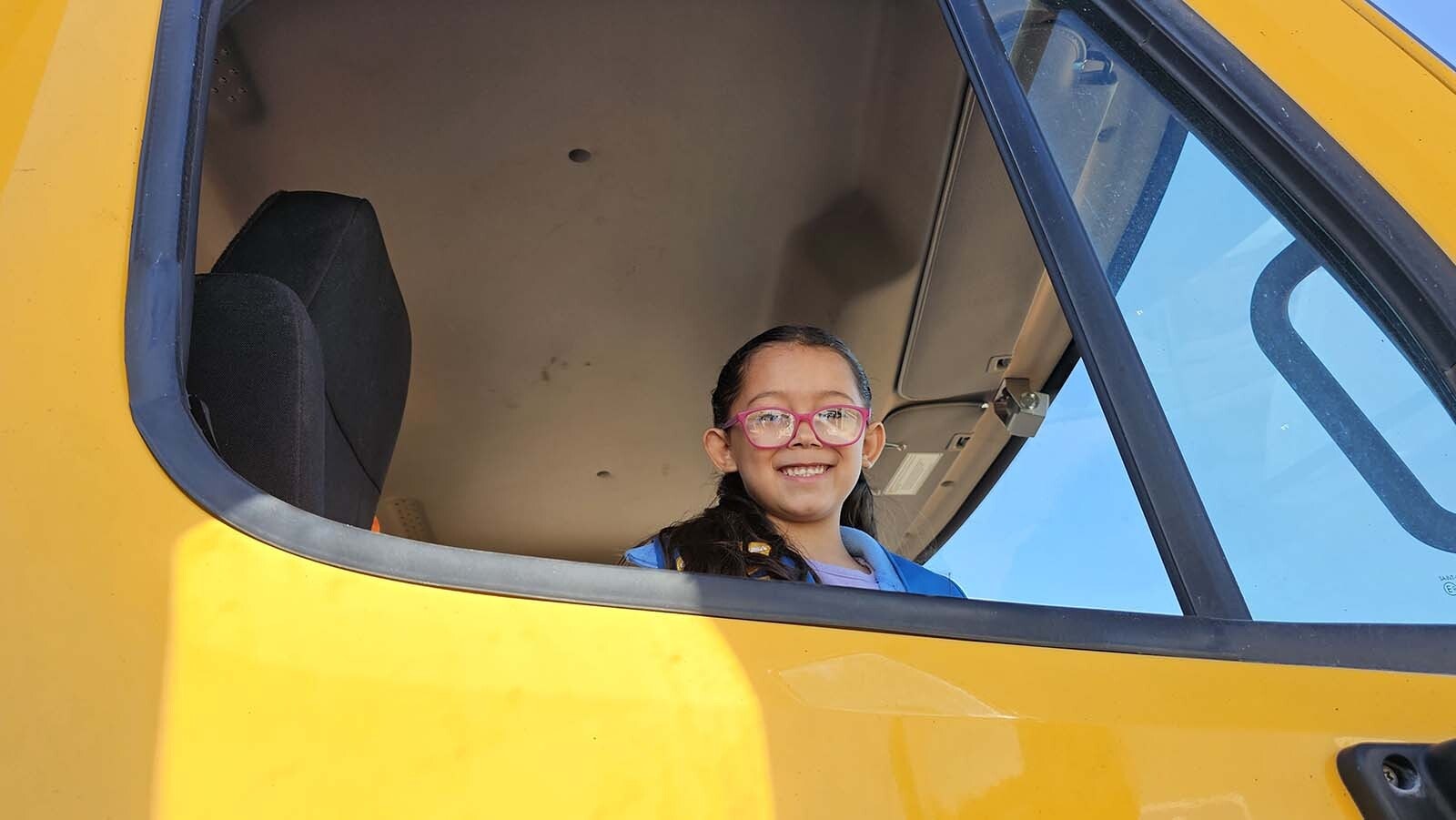 Octavia Ambrose smiles as she looks out not he world from a truck during the annual Trucks Are For Girls Event, held every fall, at Eastern Wyoming College's Douglas campus..