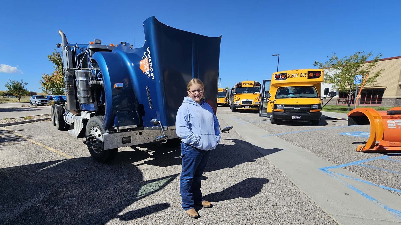A teenager named Shelby poses in front of her favorite truck Snowplows, big trucks, and a snow plow were just a few of the trucks on hand  during the annual Trucks Are For Girls Event, held every fall, at Eastern Wyoming College's Douglas campus.