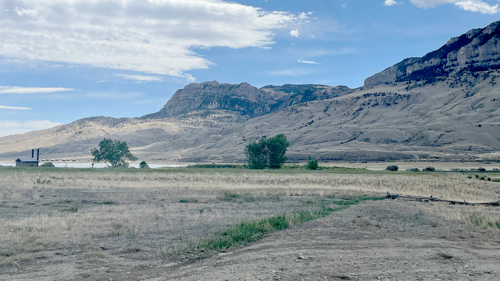 The same area is shown today with Buffalo Bill Reservoir and Sheep Mountain in the background.