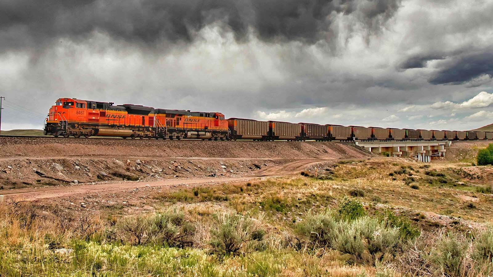 A coal train rolls under stormy skies near Glendo, Wyoming. Union Pacific and Norfolk Southern's bid to create the largest rail merger in history was rejected last week by federal regulators. The decision gives breathing room to competitors who warned the deal would raise costs for Wyoming coal producers. Now, BNSF Railway hauls Powder River Basin coal across the West before handing off the shipments to Norfolk Southern.