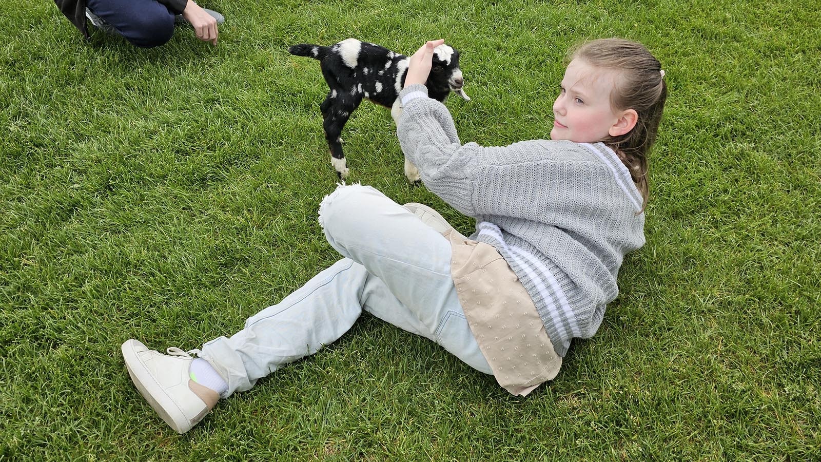 Gwendolyn Camphouse, 9, pets a baby goat at Sun Valley Park. Her family says Camphouse is "obsessed" with any animal that lives on a farm. That now includes cute, floppy-eared Nubian goats.