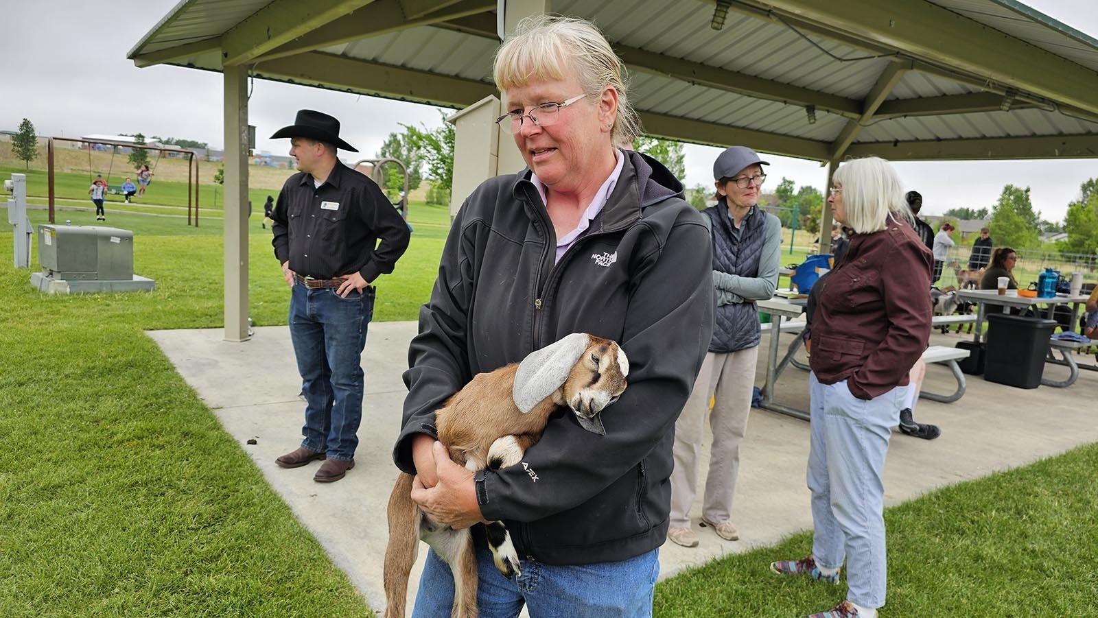 Wyoming Dairy Goat Association Anne Larson holds a baby goat.