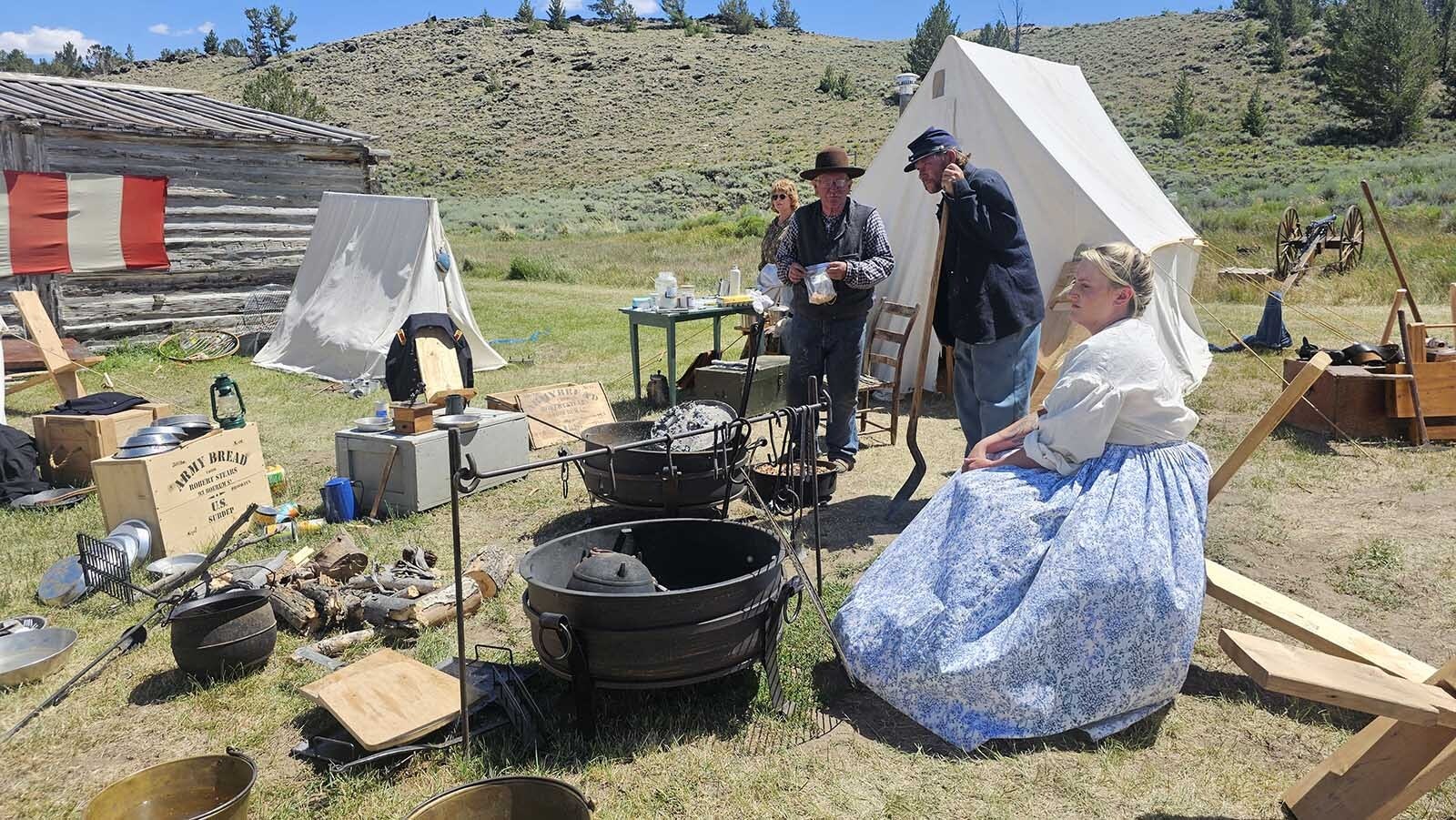 Platte Bridge Company starts to gather around for a serving of peach cobbler during Gold Rush Days at South Pass City.