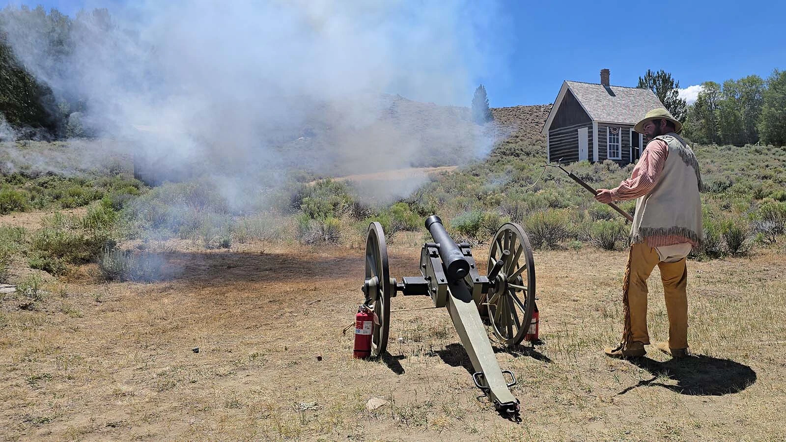 Josh Camp lights the cannon during Gold Rush Days at South Pass City.