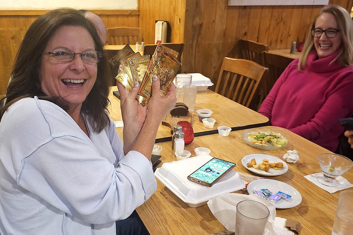 Laura Hoch holds up goldback bills she and her husband Chris intend to use to pay for their dinner at T-Joe's Steakhouse and Saloon in Cheyenne. The couple drove up all the way from Fort Collins for dinner at a place where they can spend their goldbacks.