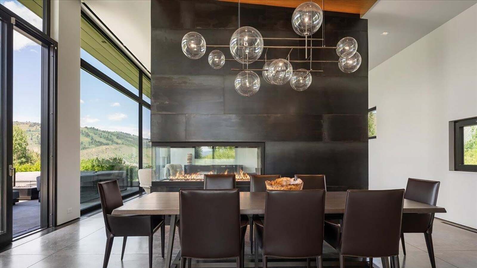 The formal dining room seats eight and sits adjacent to a three sided gas fireplace and picture windows with a stunning view.