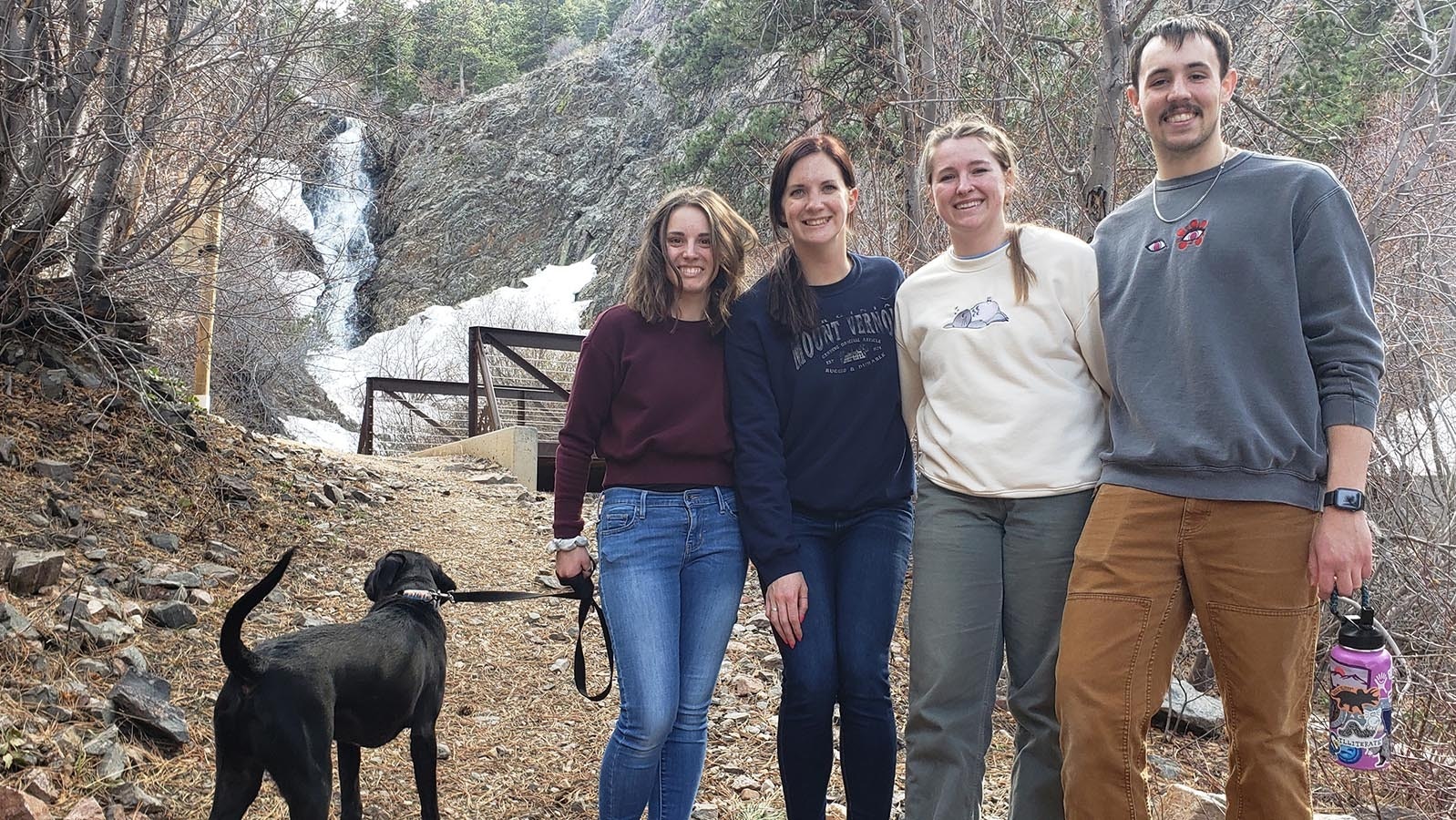 Goose the dog with owner Josie Anhom, who recently graduated from occupational therapy school, celebrates with friends Mariah Stolz of Helena, Lindsay Lee of Bozeman and brother Luke Anhom at Garden Creek Falls.