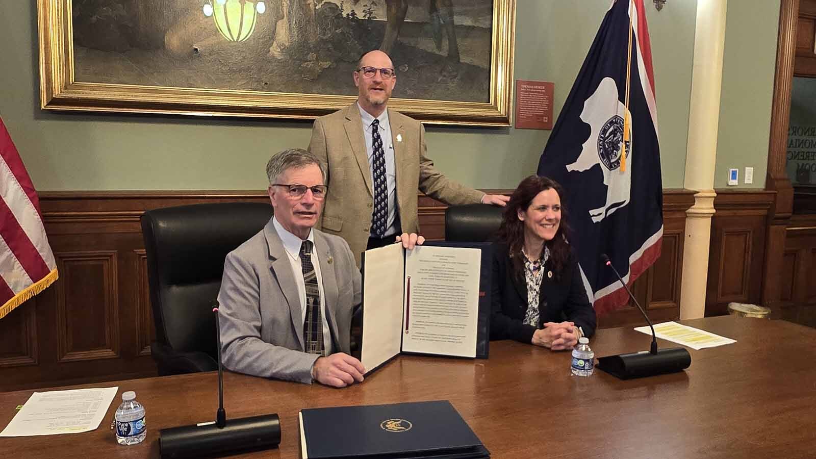 From left, Gov. Mark Gordon, Wyoming Department of Environmental Quality Director Todd Parfitt. and Nuclear Regulatory Commission Office of Nuclear Material Safety and Safeguards Director Andrea Kock pose for a photo after signing an agreement that allows Wyoming to regulate radioactive byproducts from mining rare earth minerals.