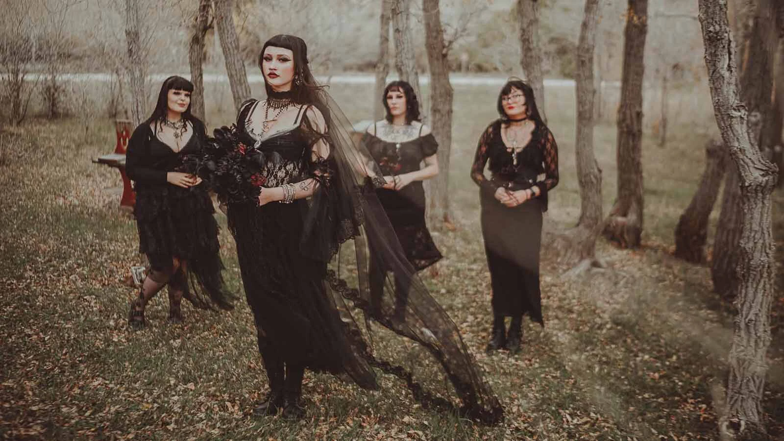 Renee Rotting, center, stands with members of her bridal party during her gothic wedding.