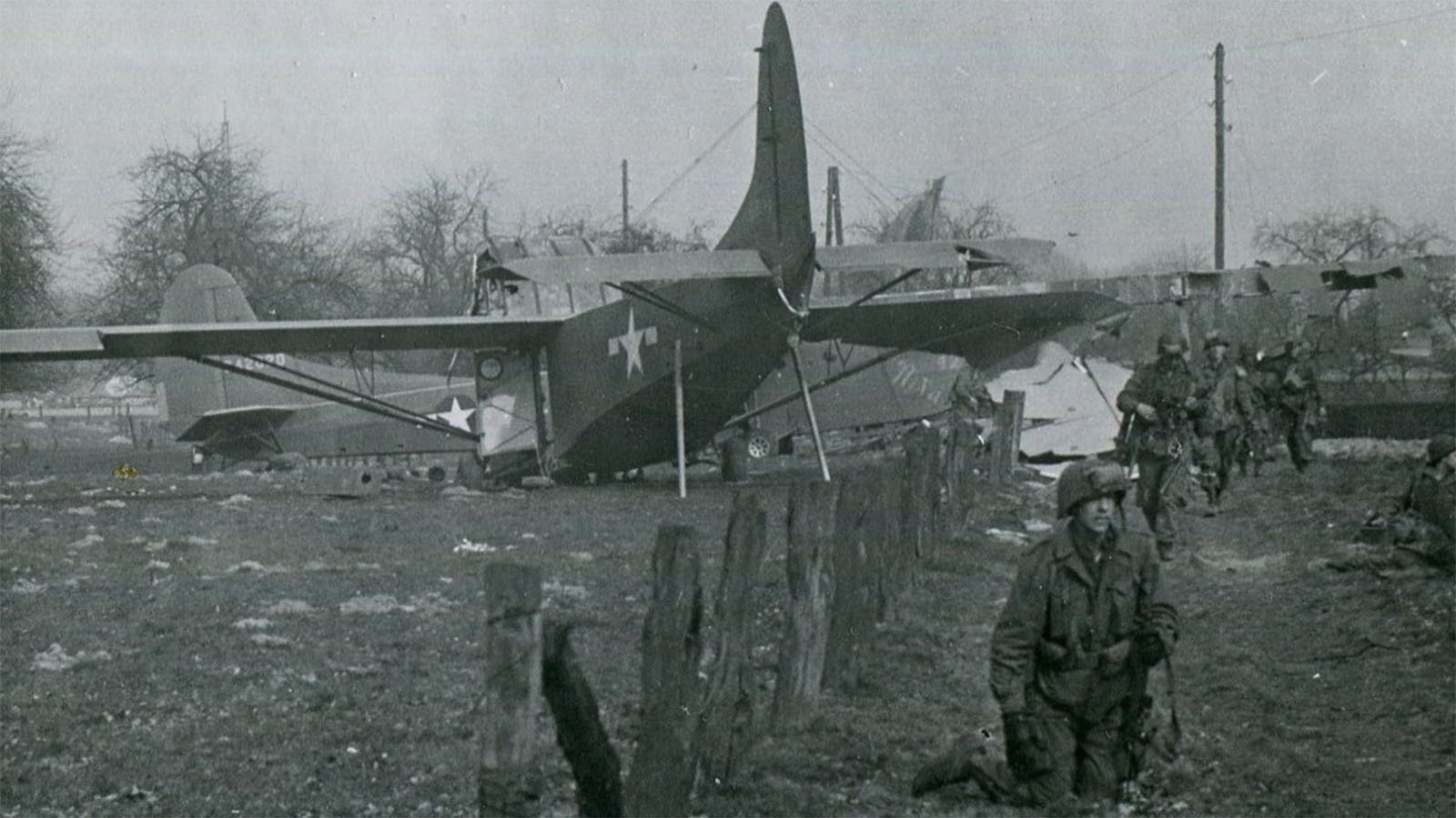 A glider and troops on the ground near Wesel, Germany during Operation Varsity in March 1945.