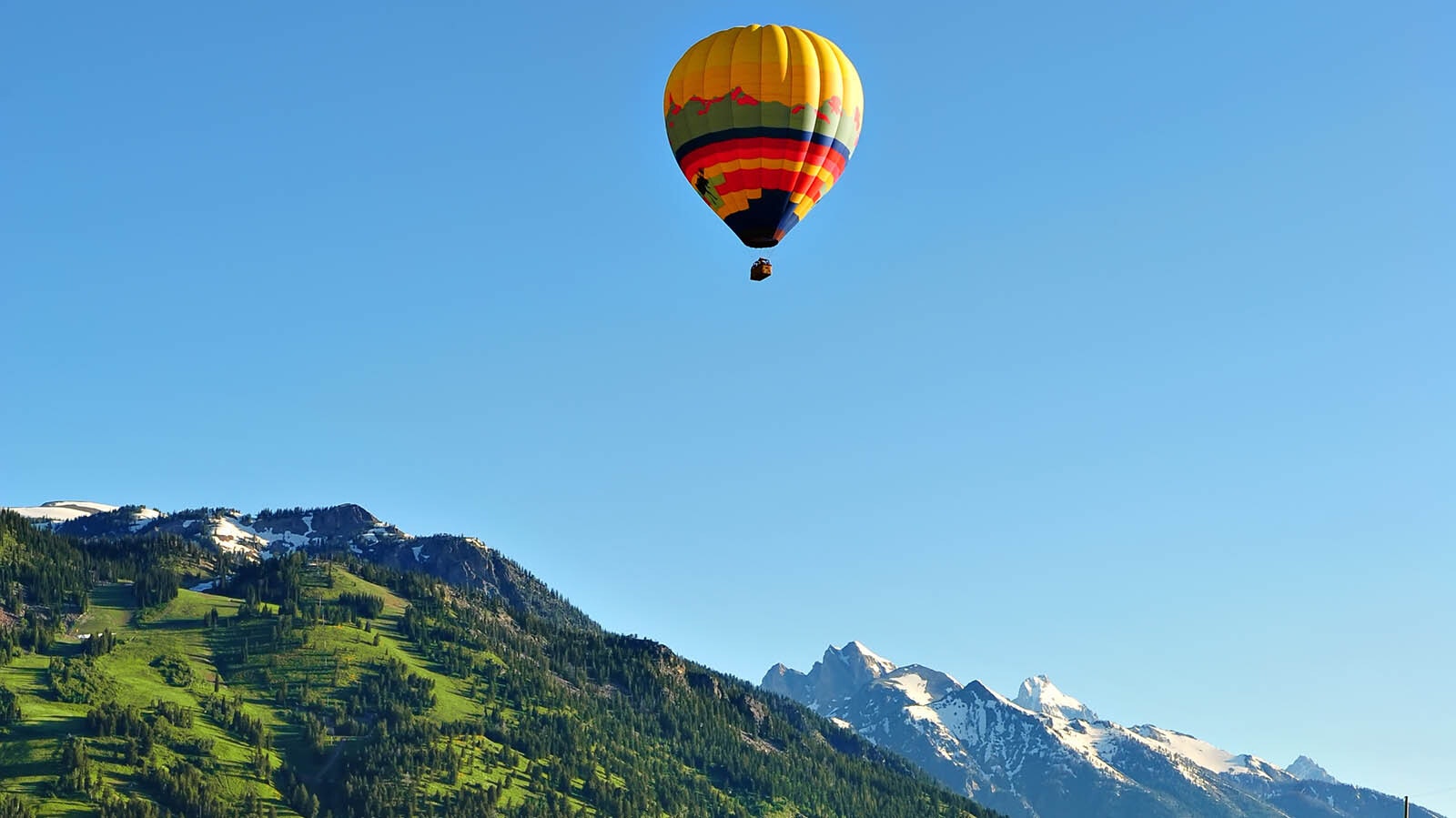 A hot-air balloon floats over the Grand Tetons in northwest Wyoming in this file photo.