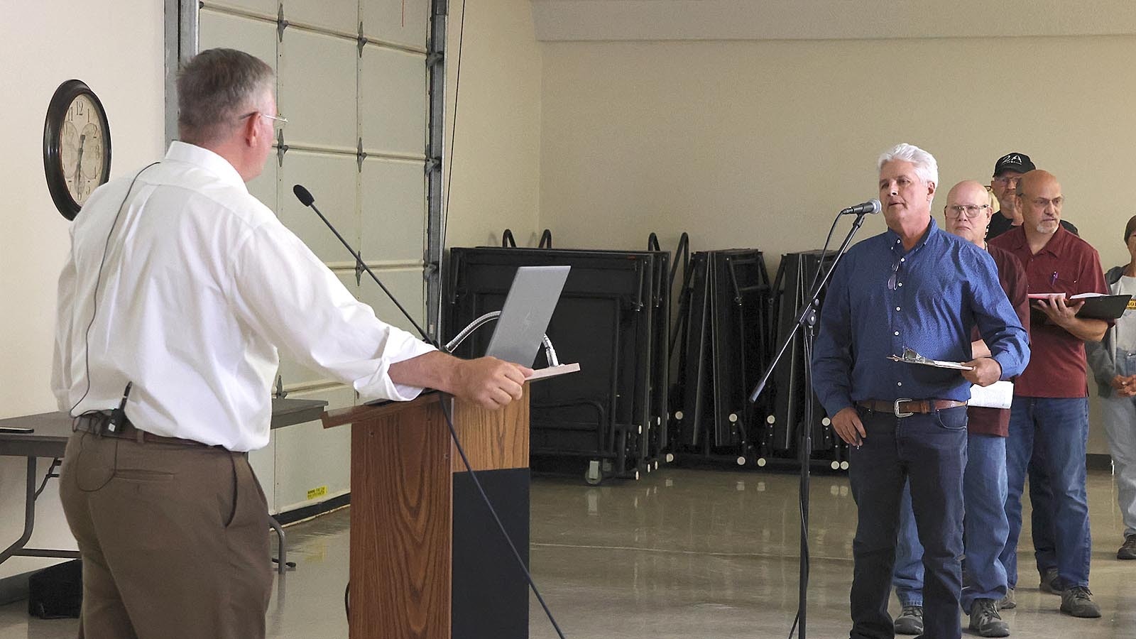 Chris Navarro, right, questions Kyle True about the number of trucks that need to travel down Coates Road to generate $2 million for the state.