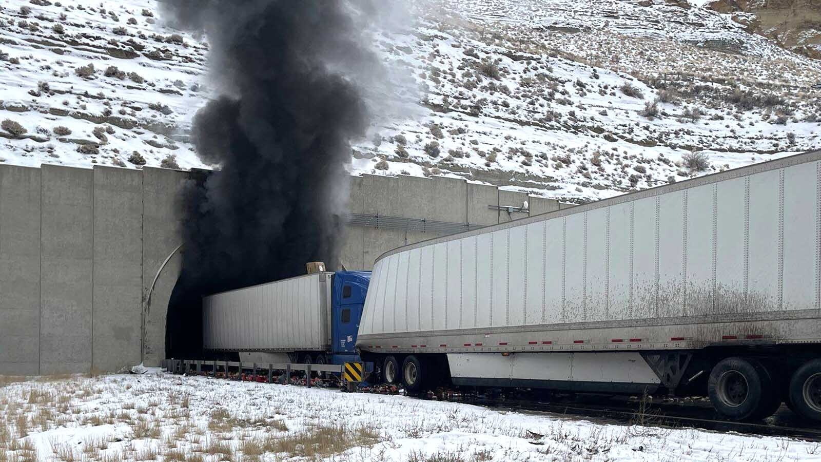 Heavy, black smoke pours from the Green River Tunnel along Interstate 80 after a Friday crash inside the tunnel.