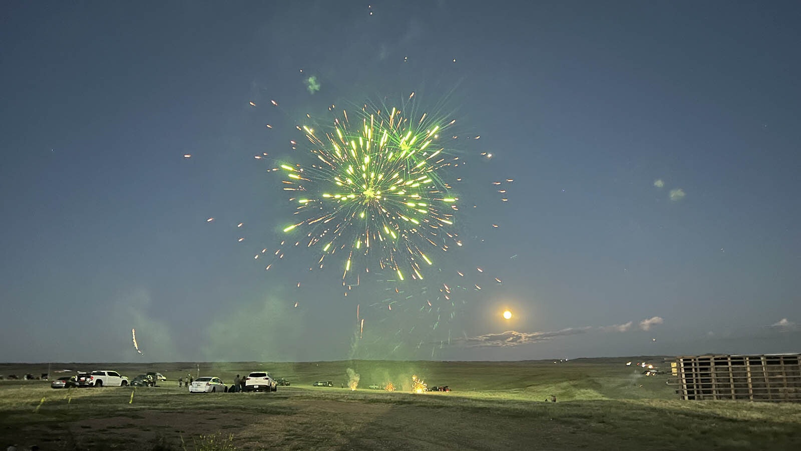 A colorful mortar shell bursts in sky during the fireworks "shoot-off" at the Wholesale Fireworks outlet south of Laramie on Sunday.