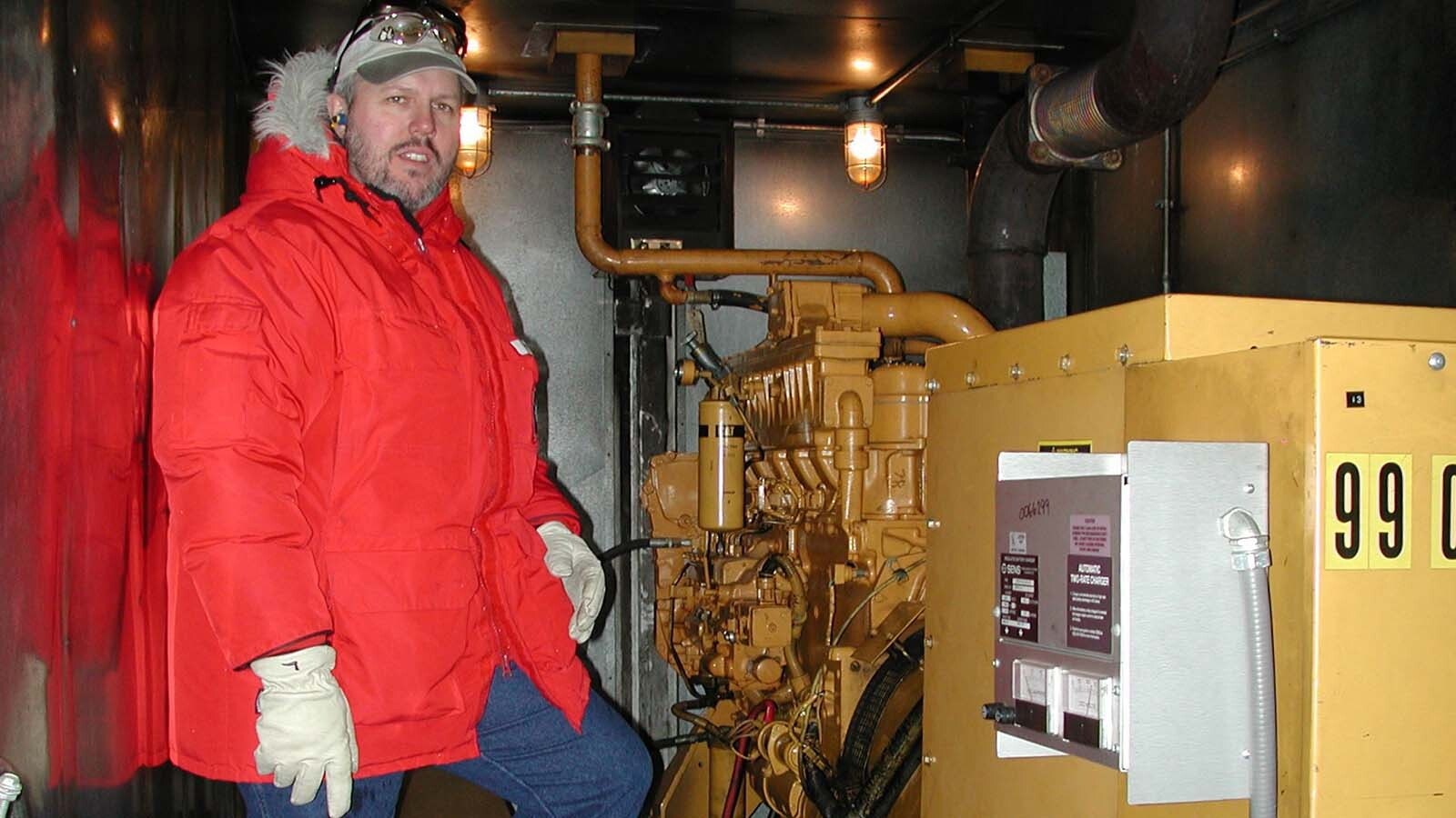 Bobby Werner checking the generator at an ice runway in Antarctica.