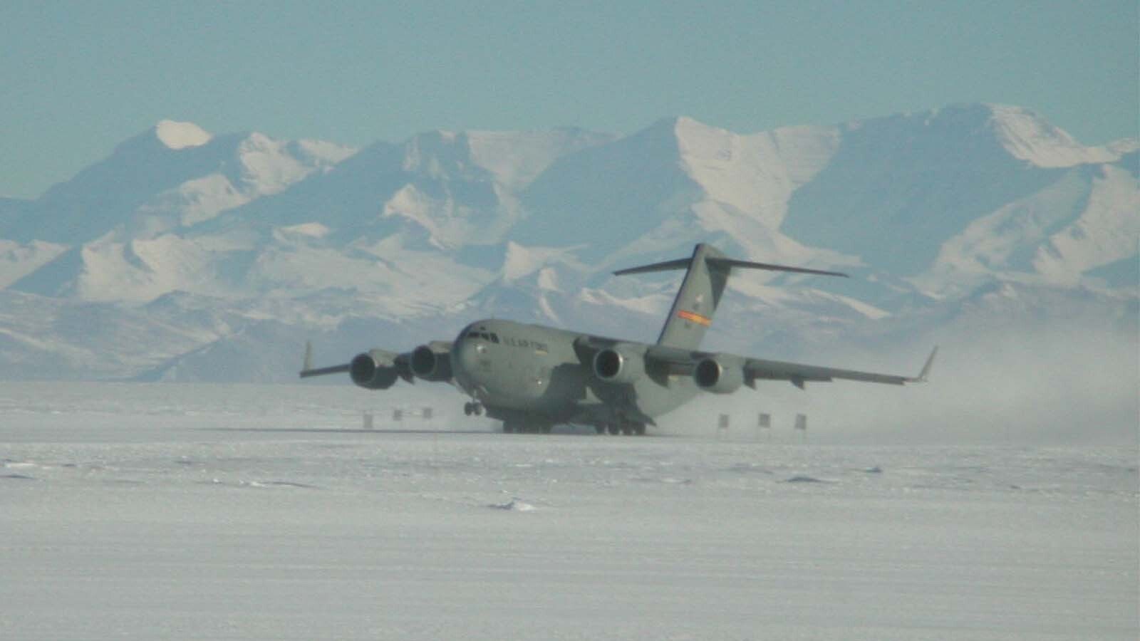 C-17 landing with the Trans Antarctic Mountains in the background.
