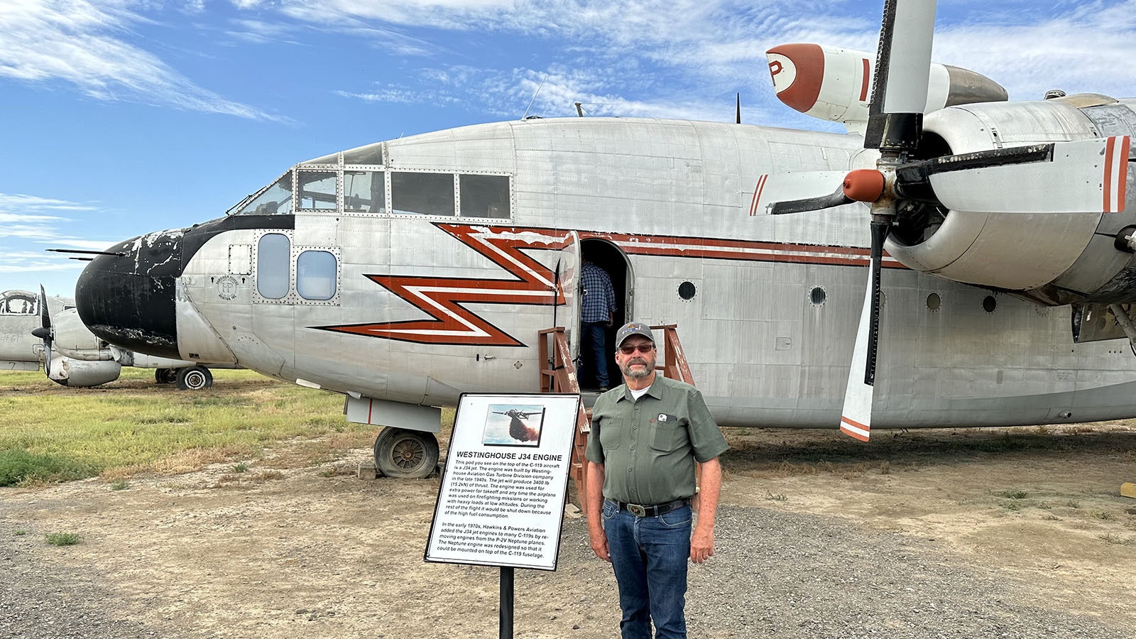 Bob Hawkins poses in front of a Fairchild C-119 at the Museum of Flight and Aerial Firefighting in Greybull. Hawkin logged hundreds of hours flying planes like this while battling forest fires. He installed the jet engine on top of the plane to increase its efficiency.