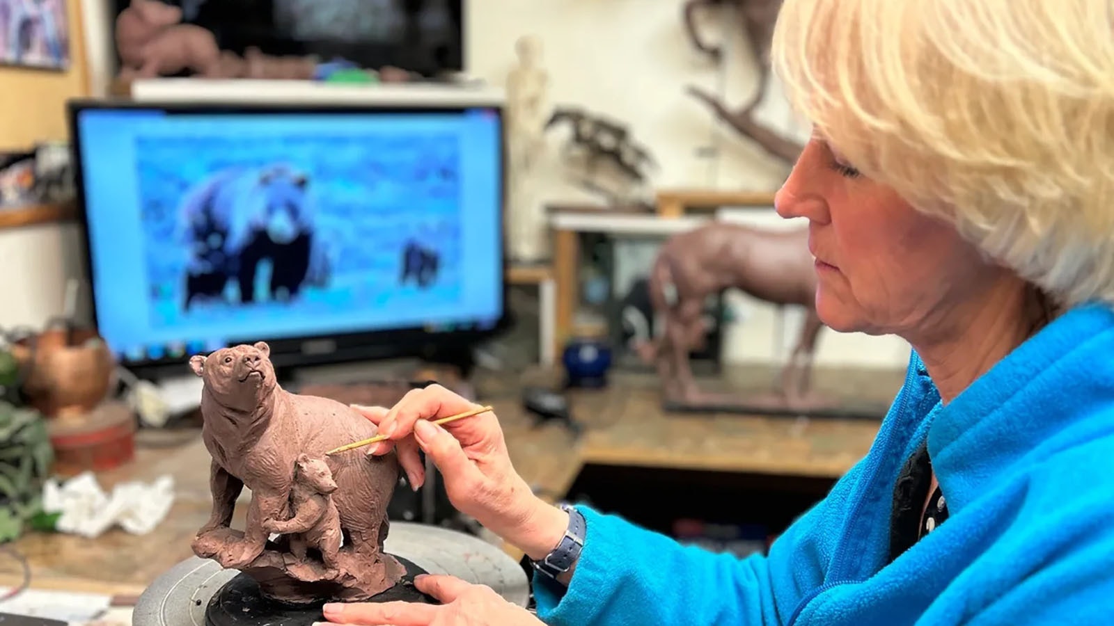 Sculptor Jocelyn Russell works on a clay model of a planned bronze memorial for Grizzly 399.