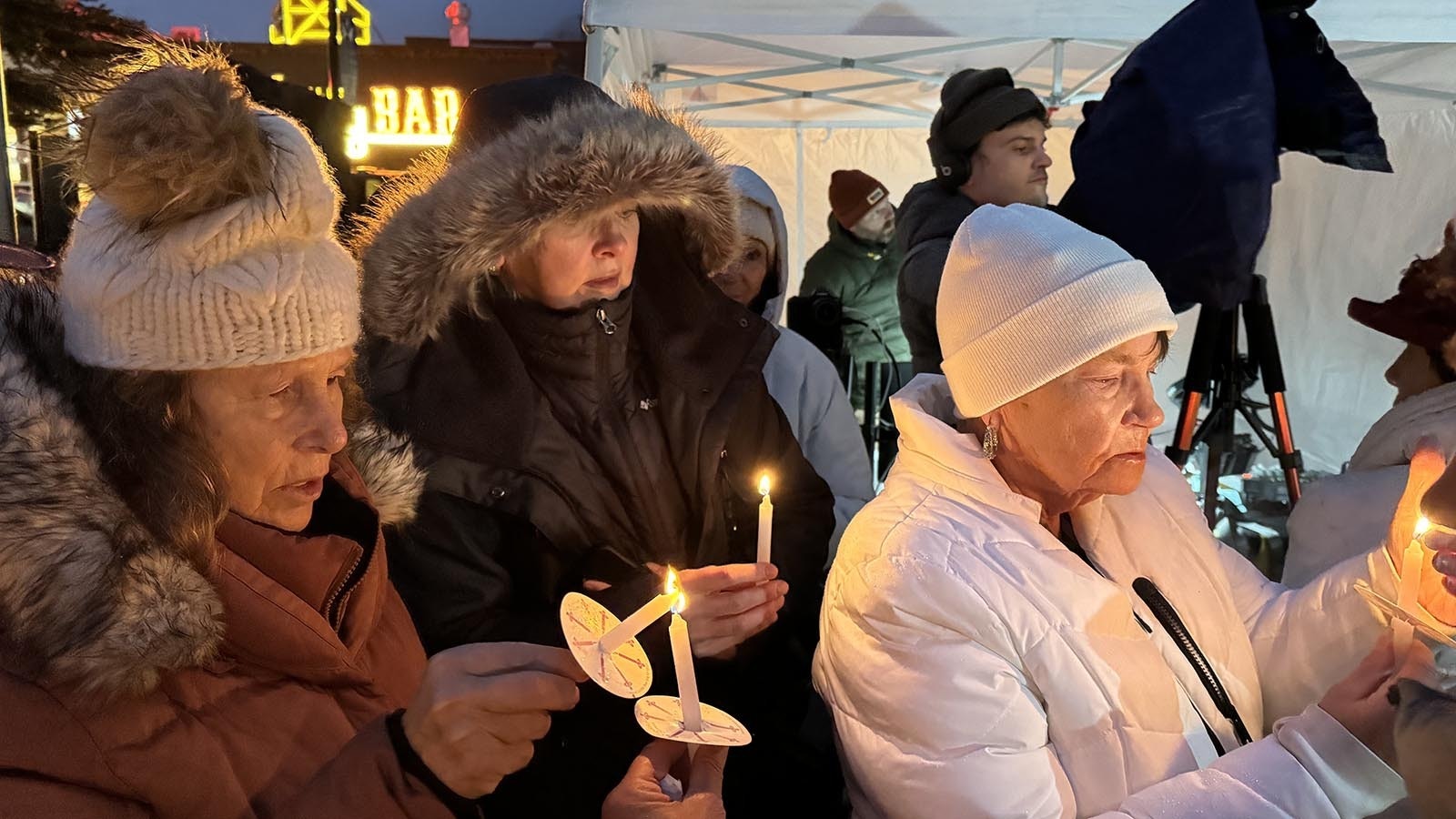 Sheila Franklin, in white, lives in Oregon and is afraid to fly, but made her first airplane trip to attend a candlelight vigil for Grizzly 399 held Nov. 2, 2024. The world's most famous bear mean a lot to her and that, "I've cried every night since she died."