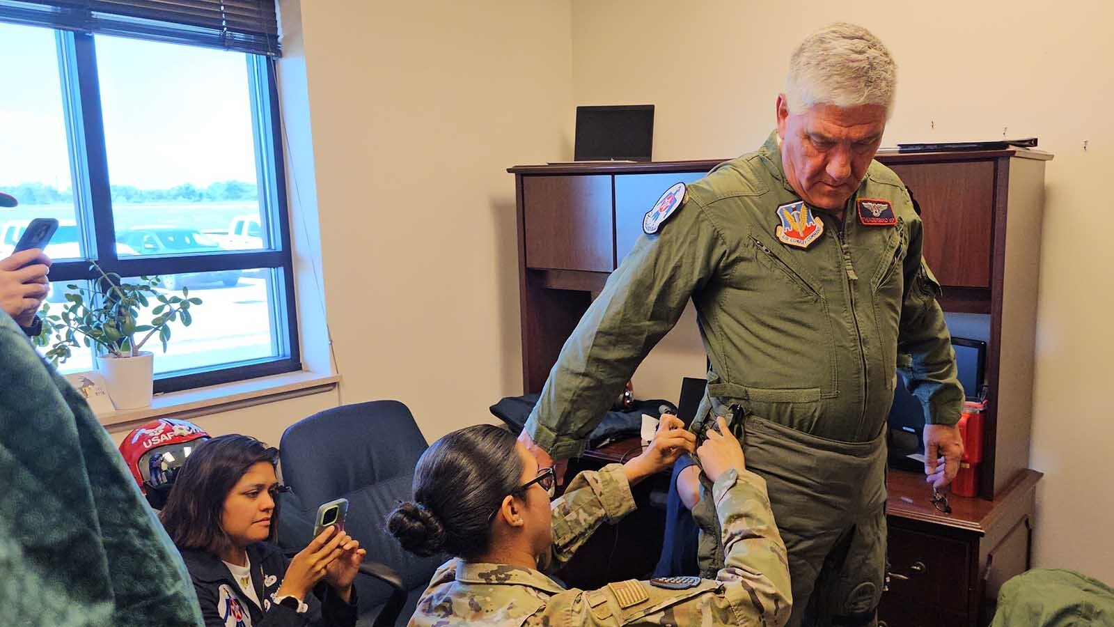 Brian "Alf" Grzegorczyk gets some assistance trying on his G-suit for the Hometown Hero Flight with the Thunderbirds.