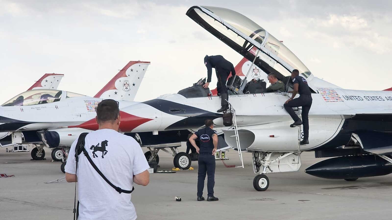 Thunderbirds crew members assist Brian "Alf" Grzegorczyk  in getting out of the F-16  Fighting Falcon jet after his Hometown Hero Flight with the Thunderbirds.