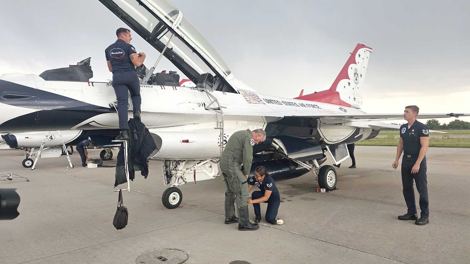 A Thunderbirds crew member helps Brian "Alf" Grzegorczyk  take off his G-suit after his Hometown Hero Flight with the Thunderbirds.