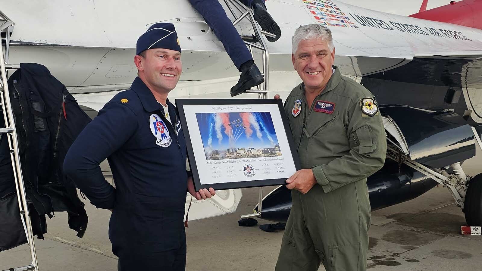 Maj. Brandon "Crime" Maxson presents ryan “Alf” Grzegorczyk with a signed photograph commemorating his Hometown Hero Flight with the Thunderbirds.