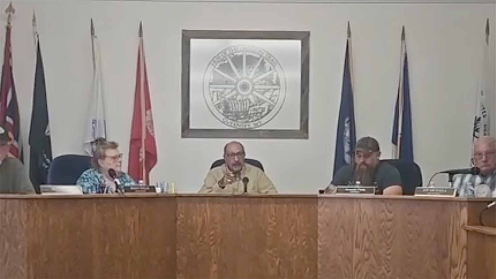 Guernsey Mayor Ed Delgado warns the daughter of a town council member about interrupting during the council's meeting Tuesday, April 21, 2026. He threatened to have her removed if she makes another outburst. Less than a minute later, she was removed for clapping.