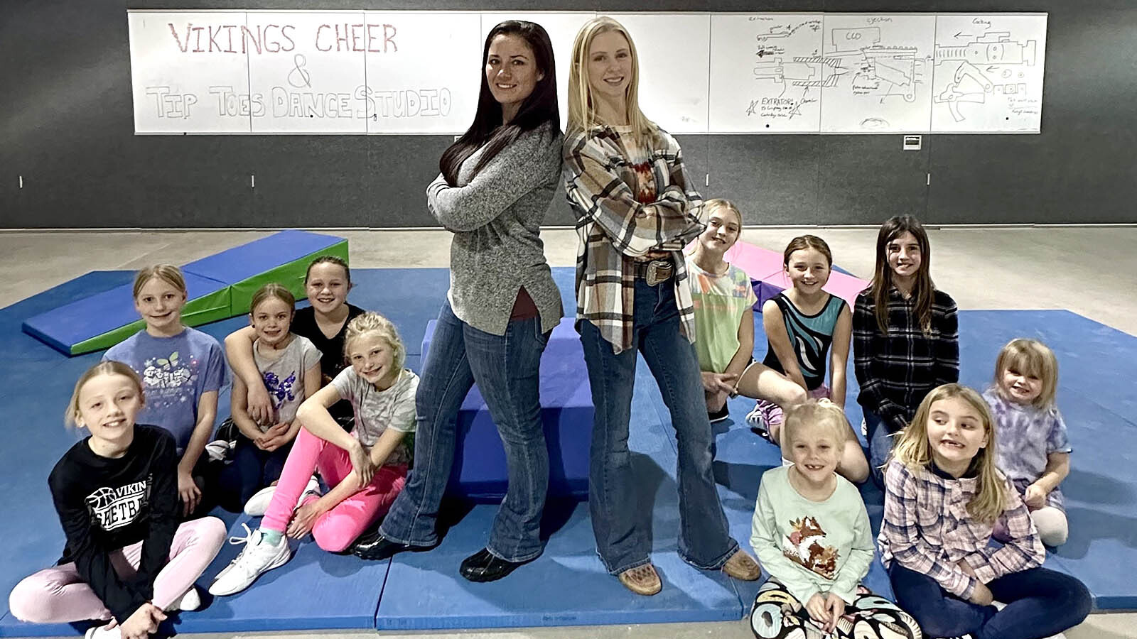 Heather Walker, left, and Jessica Schreiner with their Vikings Cheer and Dance team.
