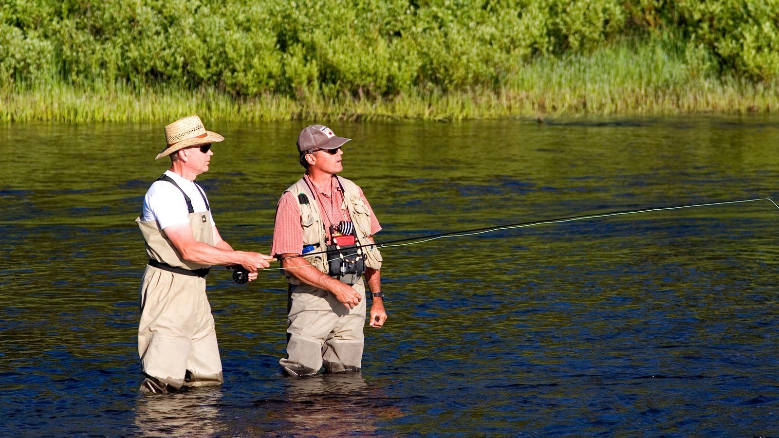 A fishing guide with a client on the Lewis River in Yellowstone National Park in this file photo.