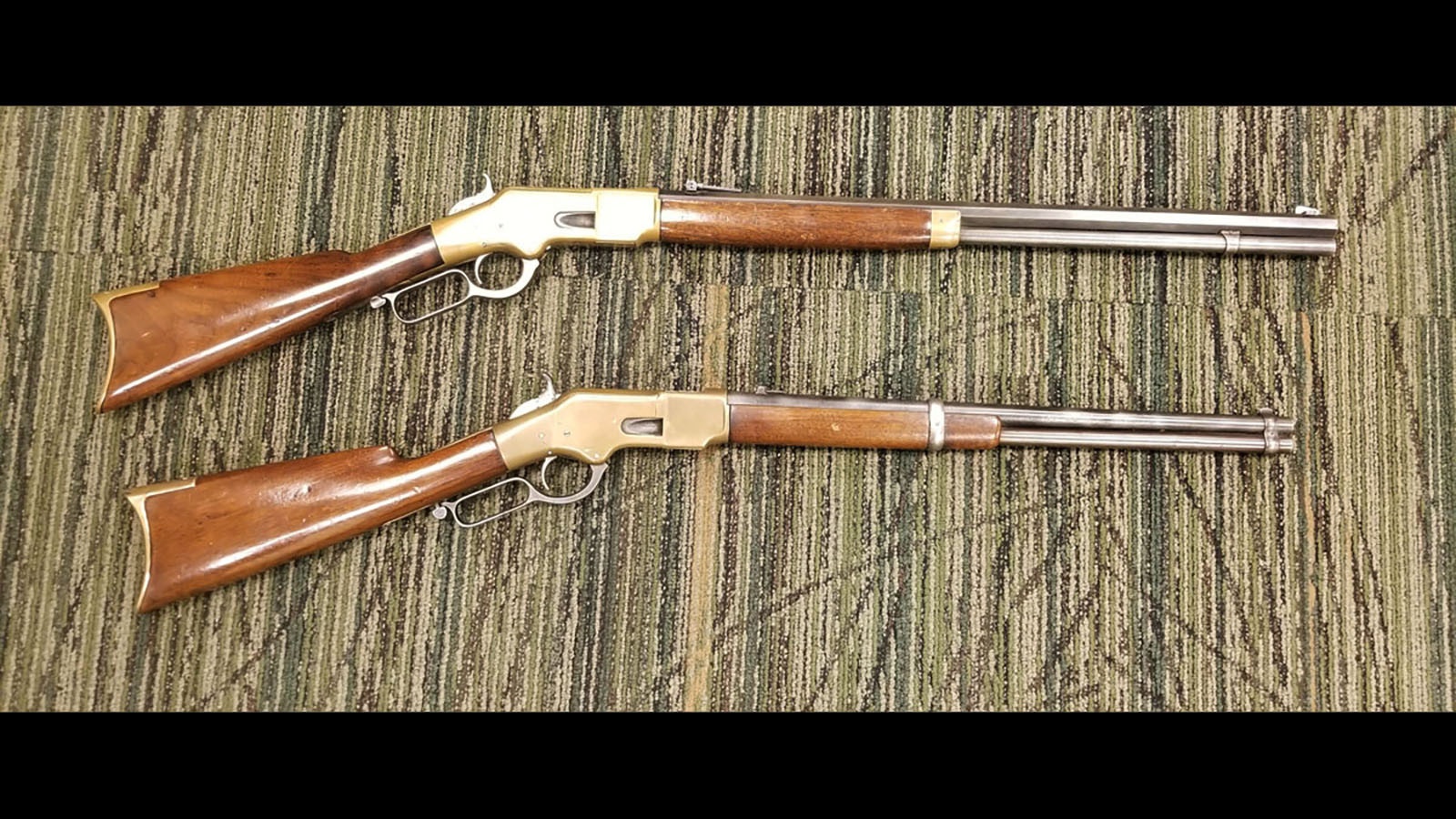 The Model 1866 Winchester, which chambered a .44-caliber rimfire cartridge, was the first true Winchester lever-action rifle. Nicknamed the “Yellow Boy” because of its brass receiver, shown here are two Model 1866s, one a full-length rifle, the other a shorter, lighter carbine.