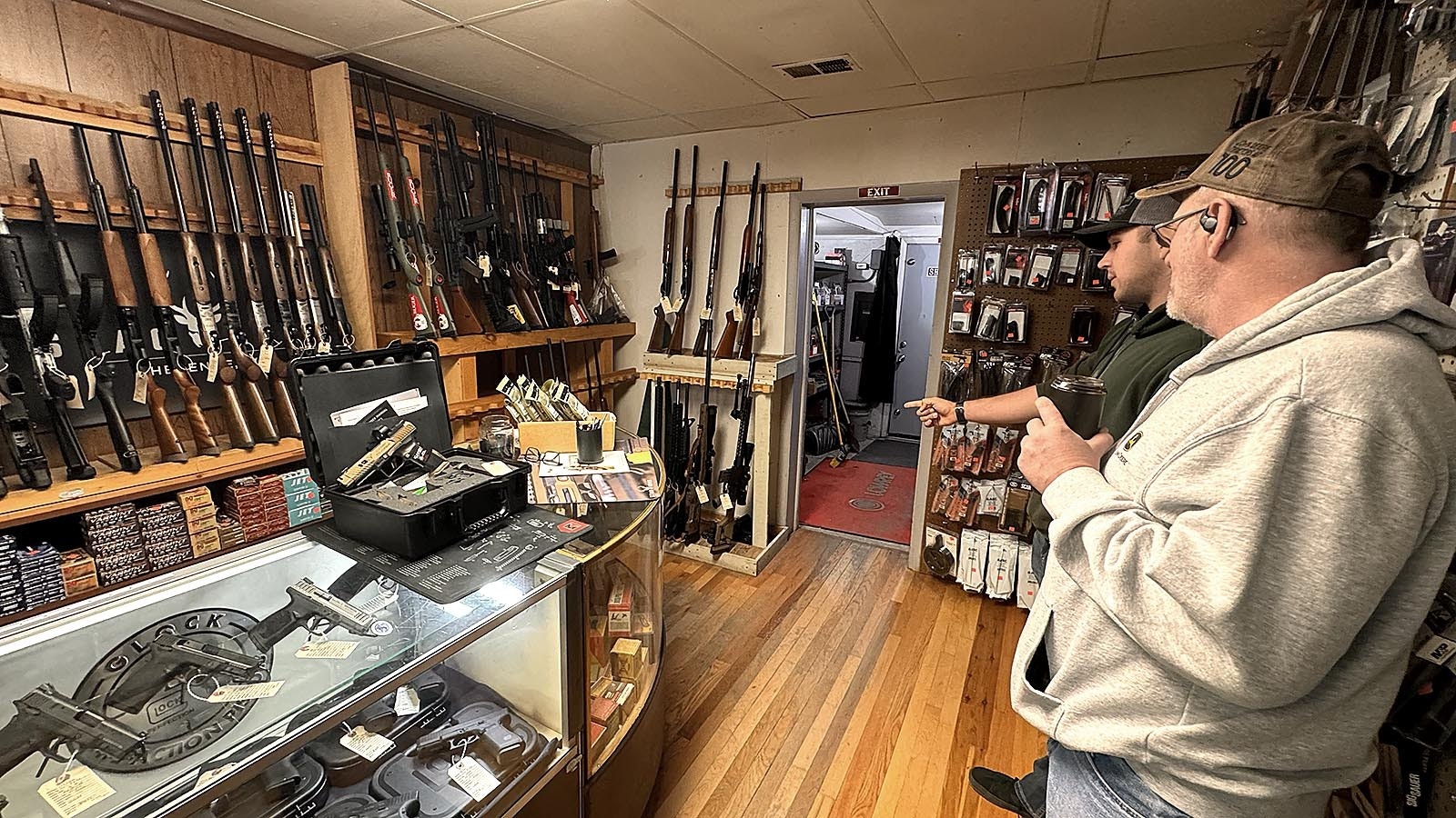 Bryan Hale, right, and his son look at the selection at Frontier Arms on Monday, two days before Christmas. Hale said he was 12 when he got his first gun. It was a Christmas gift, a Red Ryder BB gun just like in the popular moving "A Christmas Story."