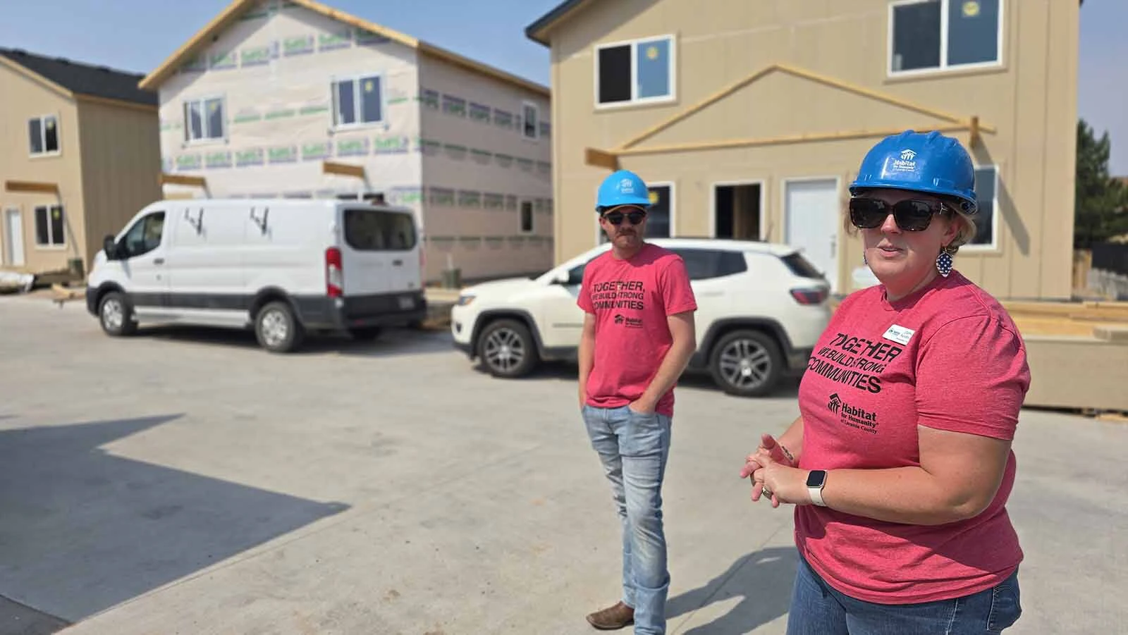 Daphney Sandoval talks about Habitat for Humanity of Laramie County's latest project, Pronghorn Crossing, which has six twin homes for 12 families while a colleague looks on.