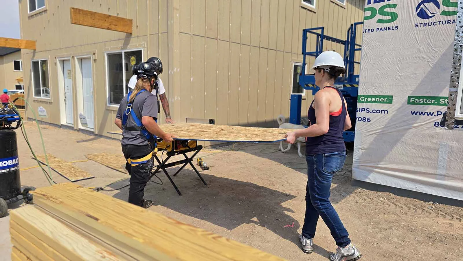 Victoria Hunt, right, helps cut boards at Pronghorn Crossing, Habitat for Humanity of Laramie County's latest project.