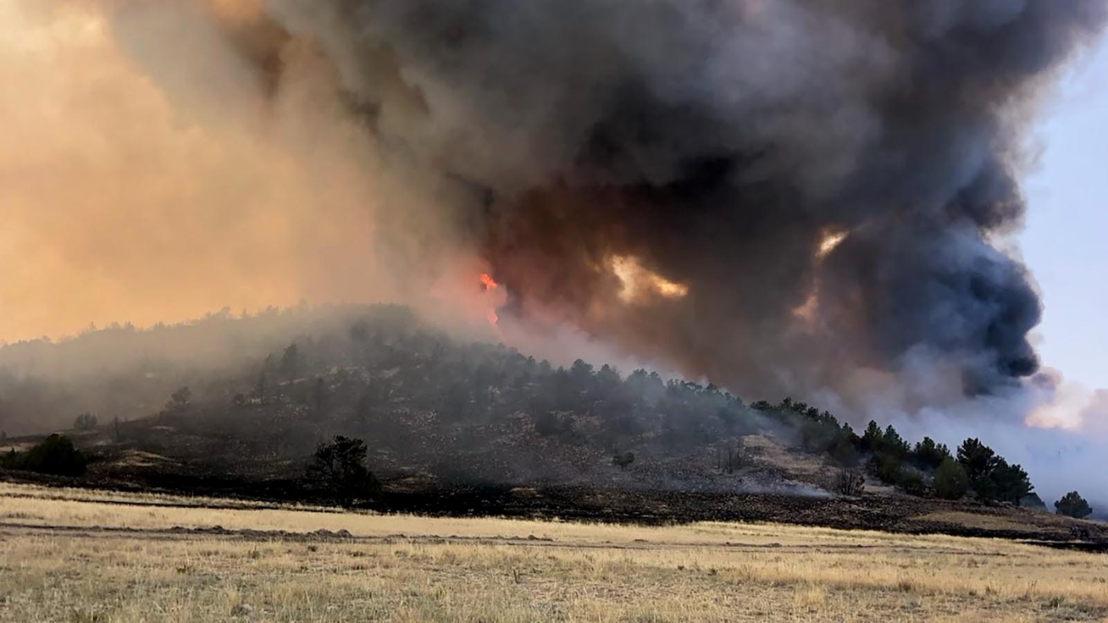 U.S. Rep. Harriet Hageman, R-Wyoming, grew up in an old homestead house near McGinnis Pass, located about 8 miles north of Guernsey, Wyoming. The century old home burned down on Wednesday. Fire from behind the home burns closer.