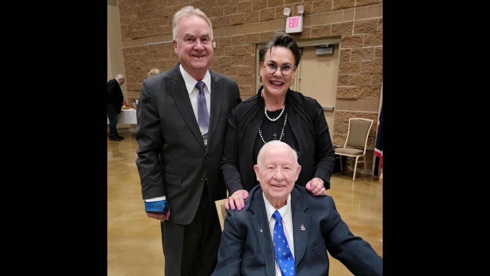 U.S. Rep. Harriet Hageman and her husband John Hageman (left) stand behind Teense Willford at an event honoring the Platte Valley icon earlier this year.