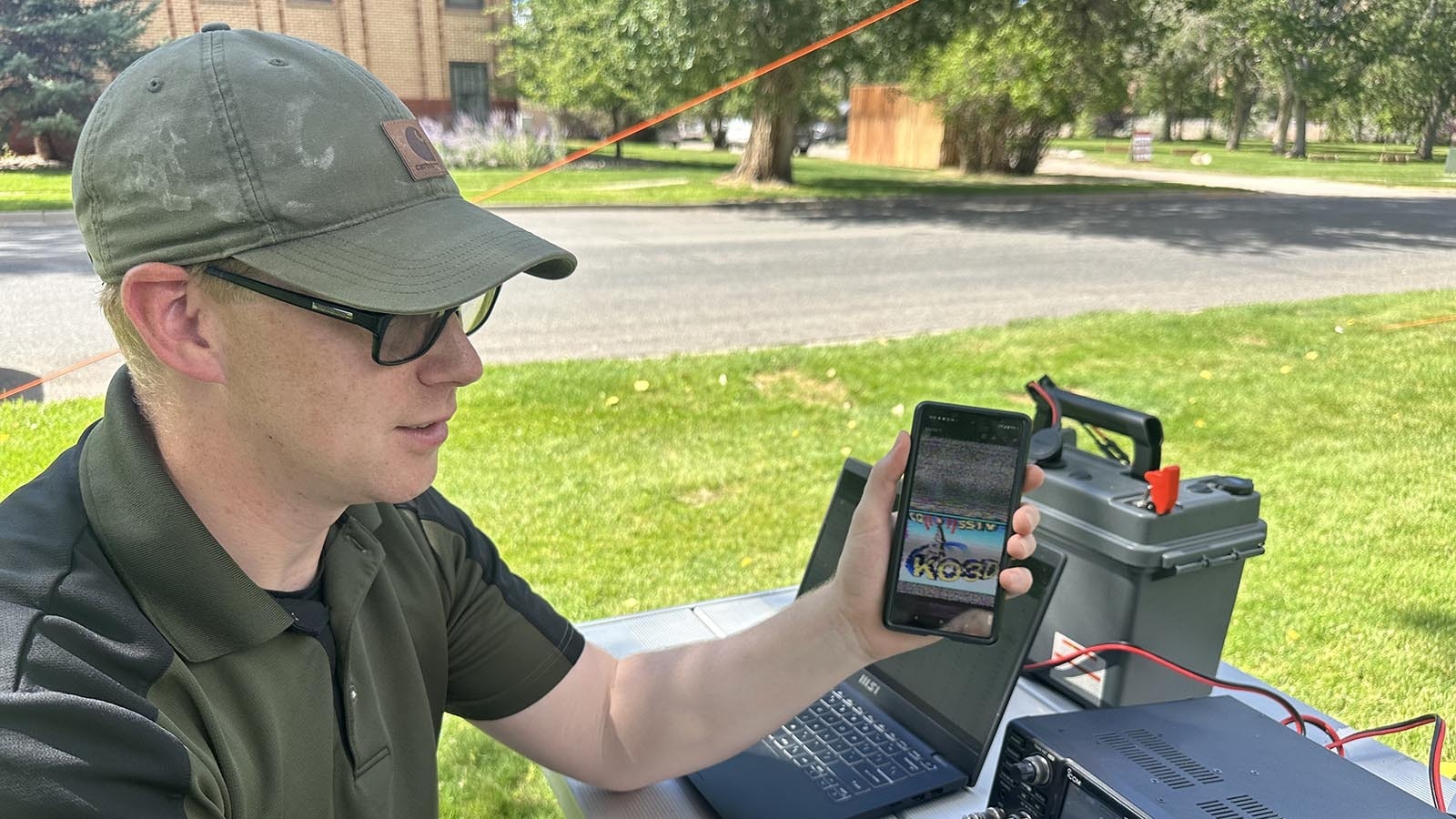 Ham operator Casey Freund decodes an image on his cell phone that transmitted from Pennsylvania.