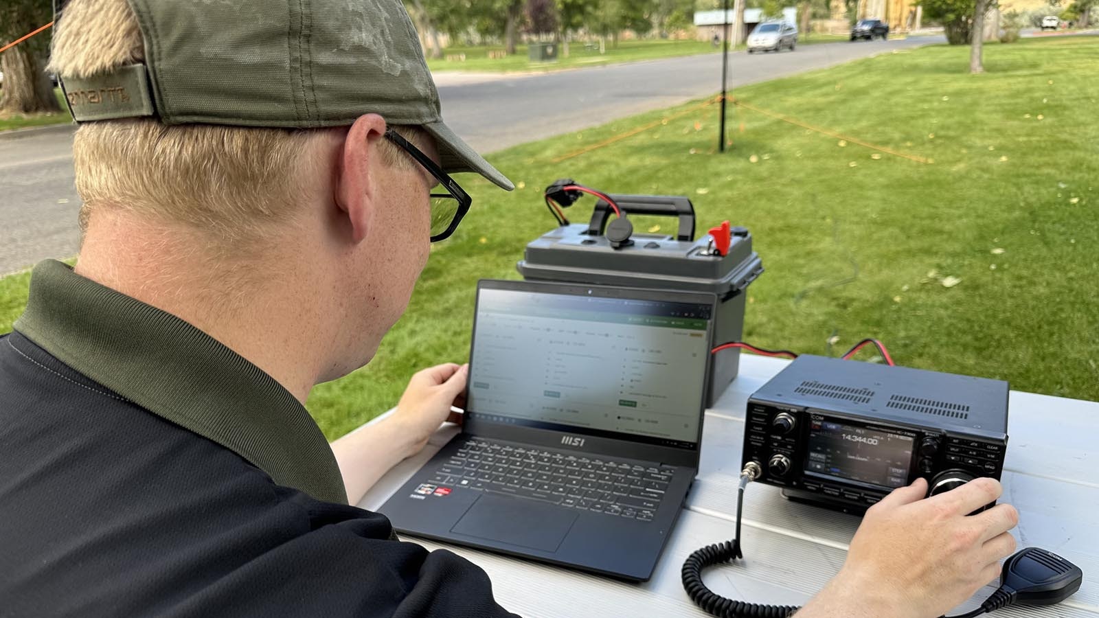 Ham radio operator Casey Freund adjusts the frequency on his radio in the Hot Springs State Park as he prepares to make contacts in the “Parks On The Air” program.