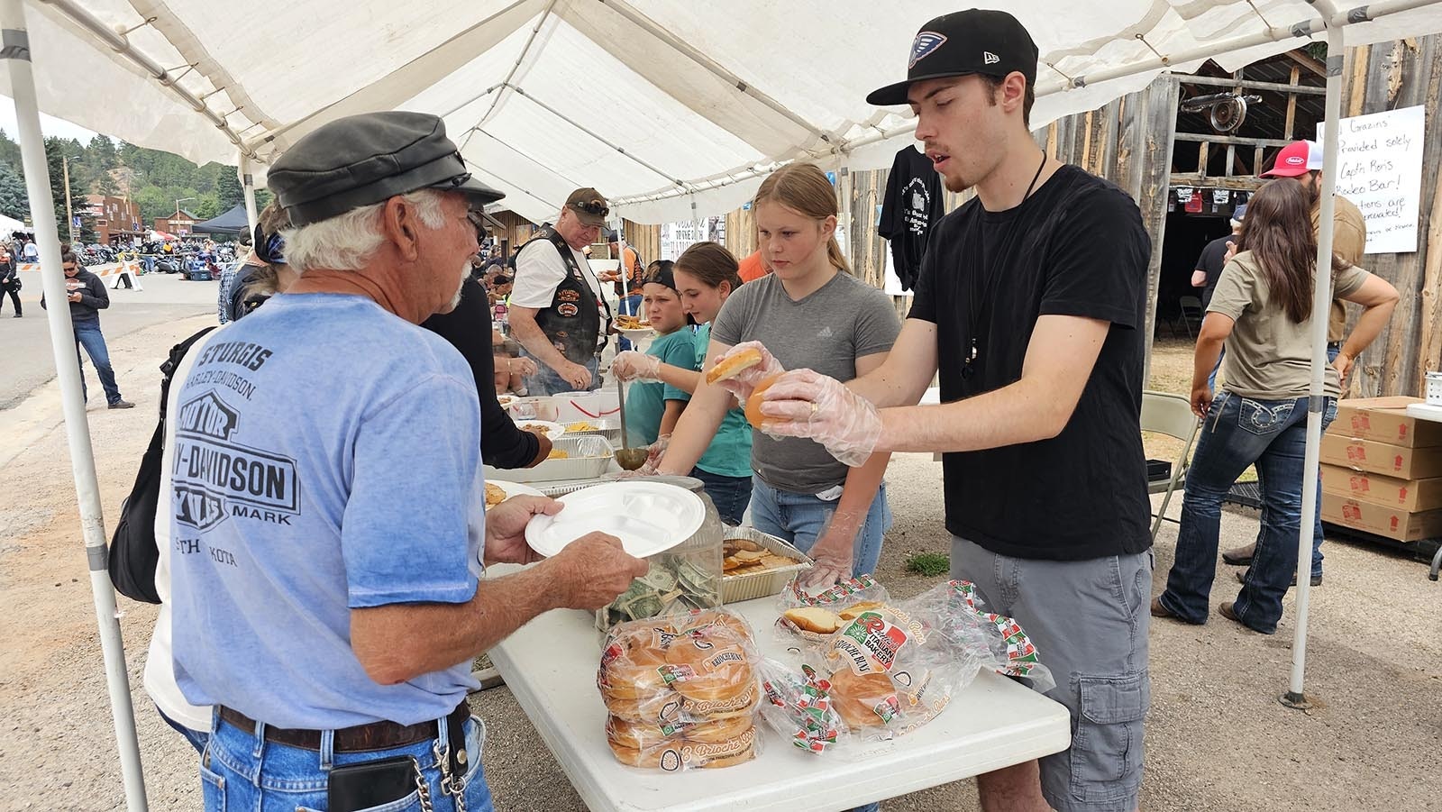 The ham part of the Ham and Jam event moves fairly quickly, with volunteers, family, and friends, helping to fill plates with a free pork sandwich, beans, and chips.