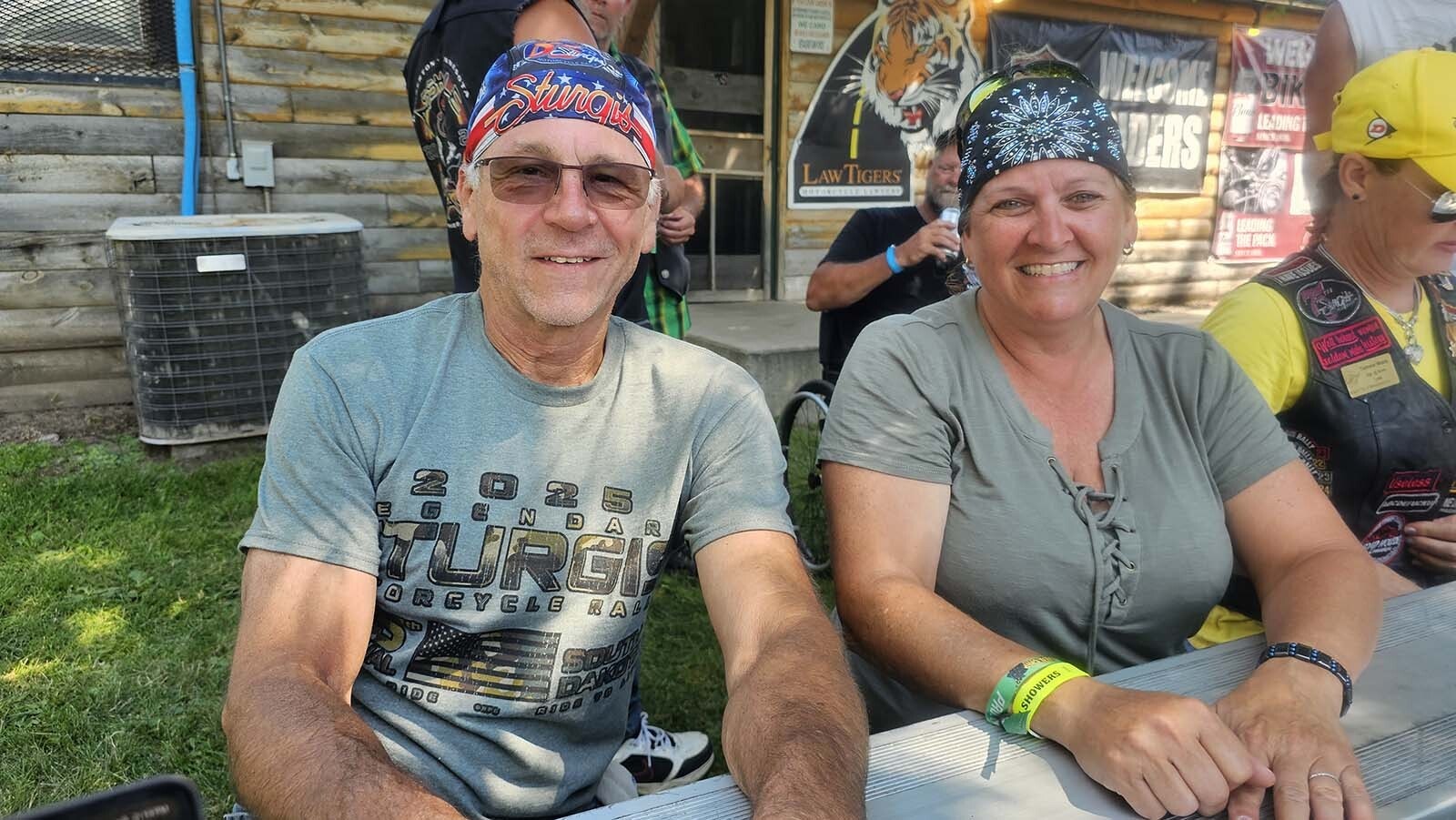Tammy Black, right, poses with a new friend she just met this year at the Sturgis Rally. Her husband, in the background, meanwhile, is talking to someone else he just met. That's par for the course at the Ham and Jam in Hulett, where the world comes to eat a free barbecue pork sandwich on Wyoming Wednesday during the Wyoming side of the Sturgis Rally.