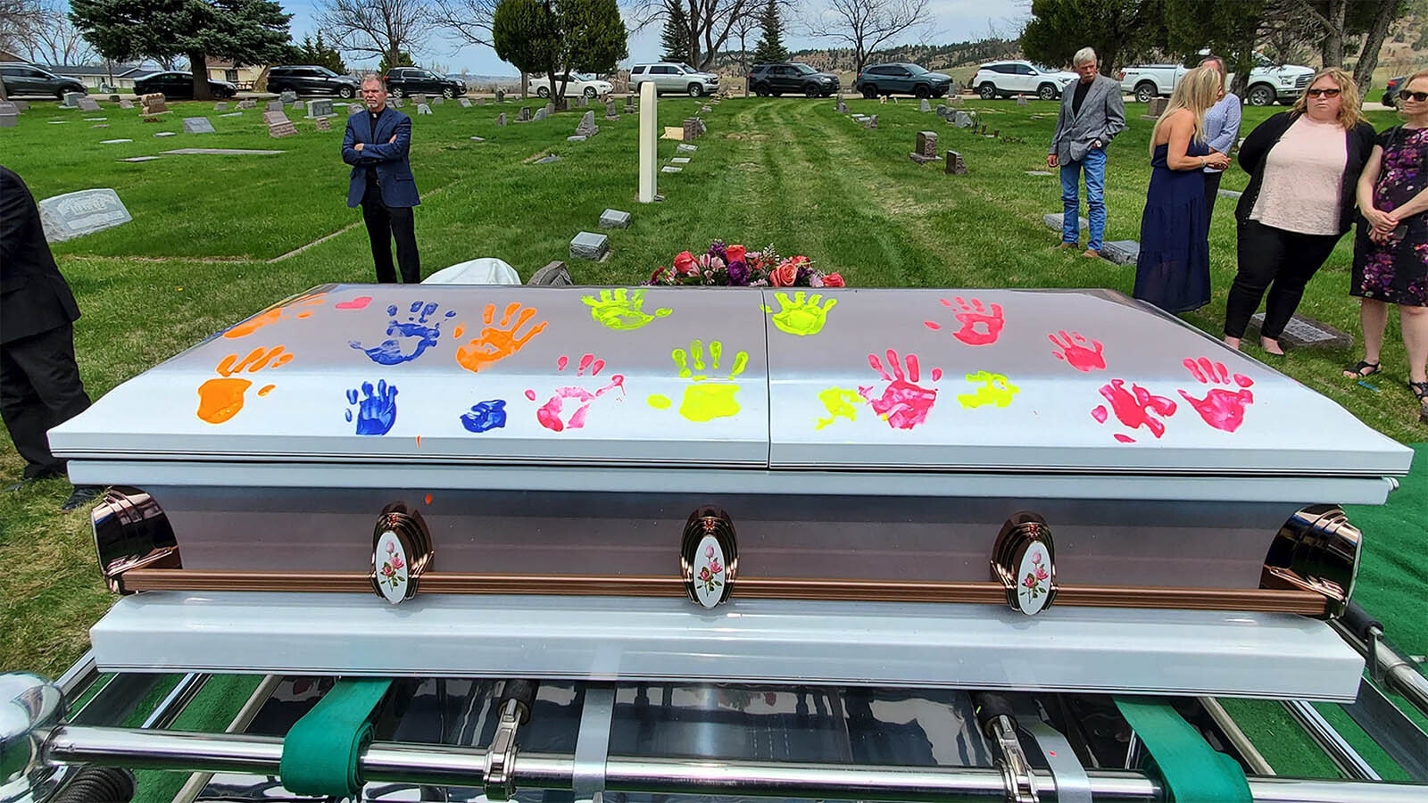 Along with burning cattle brands into caskets, other unique ways to remember loved ones include placing colorful handprints on them.