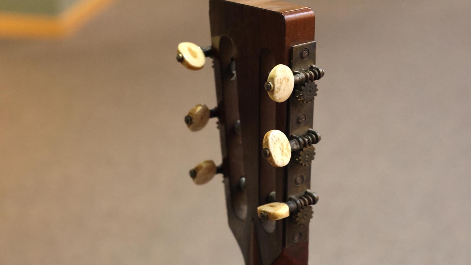 Authentic ivory pegs are on the 1870s parlor guitar.