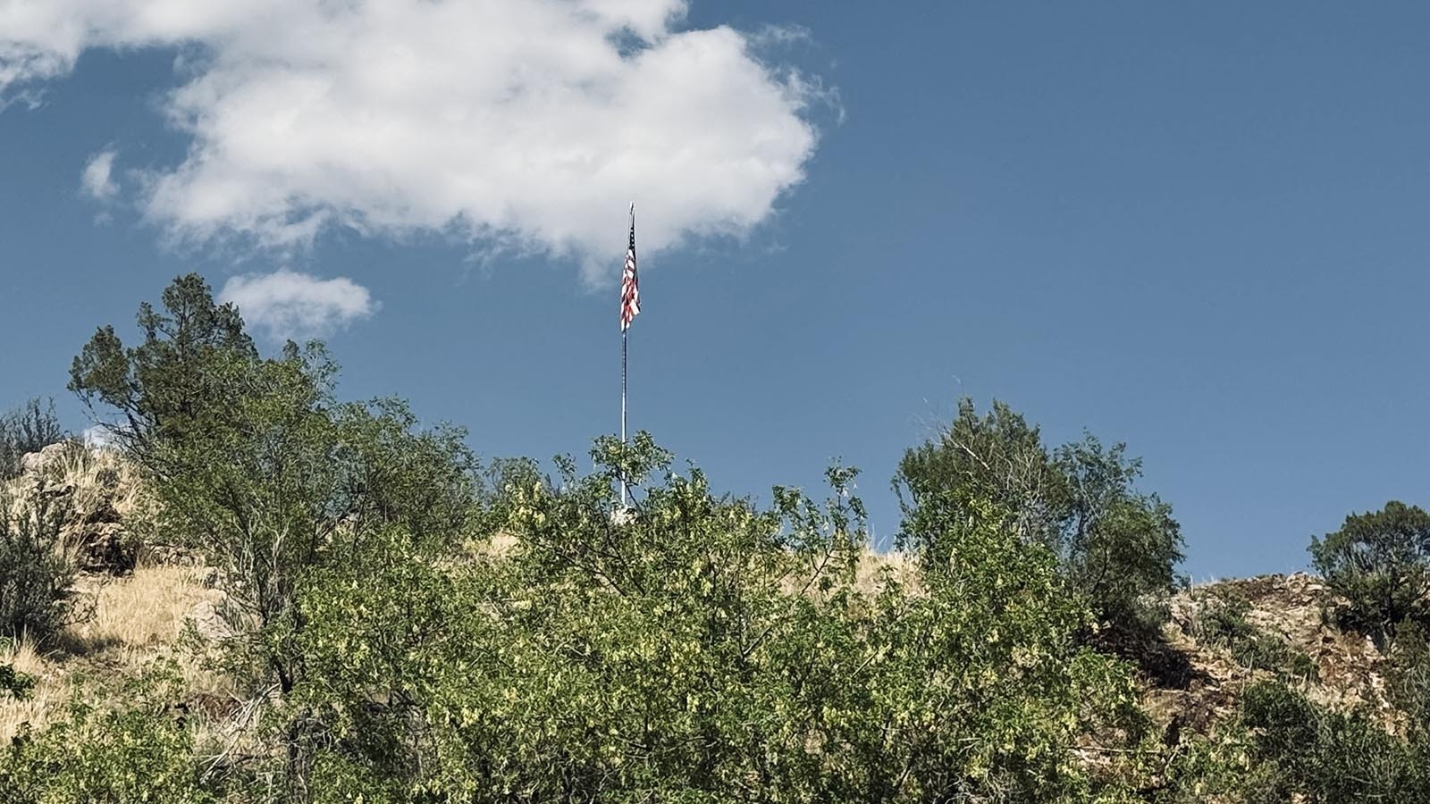 The American flag still waves over the town of Hartville, which escaped a wildfire that nearly destroyed the entire town.