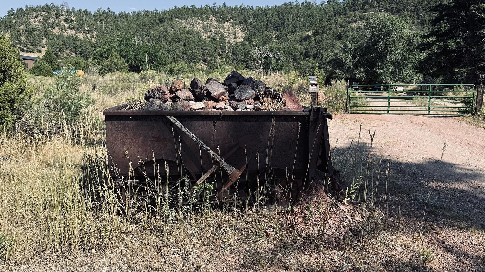 A cart filled with iron ore stands at the beginning of a driveway off of Main Street in Hartville, a reminder of the town's past.