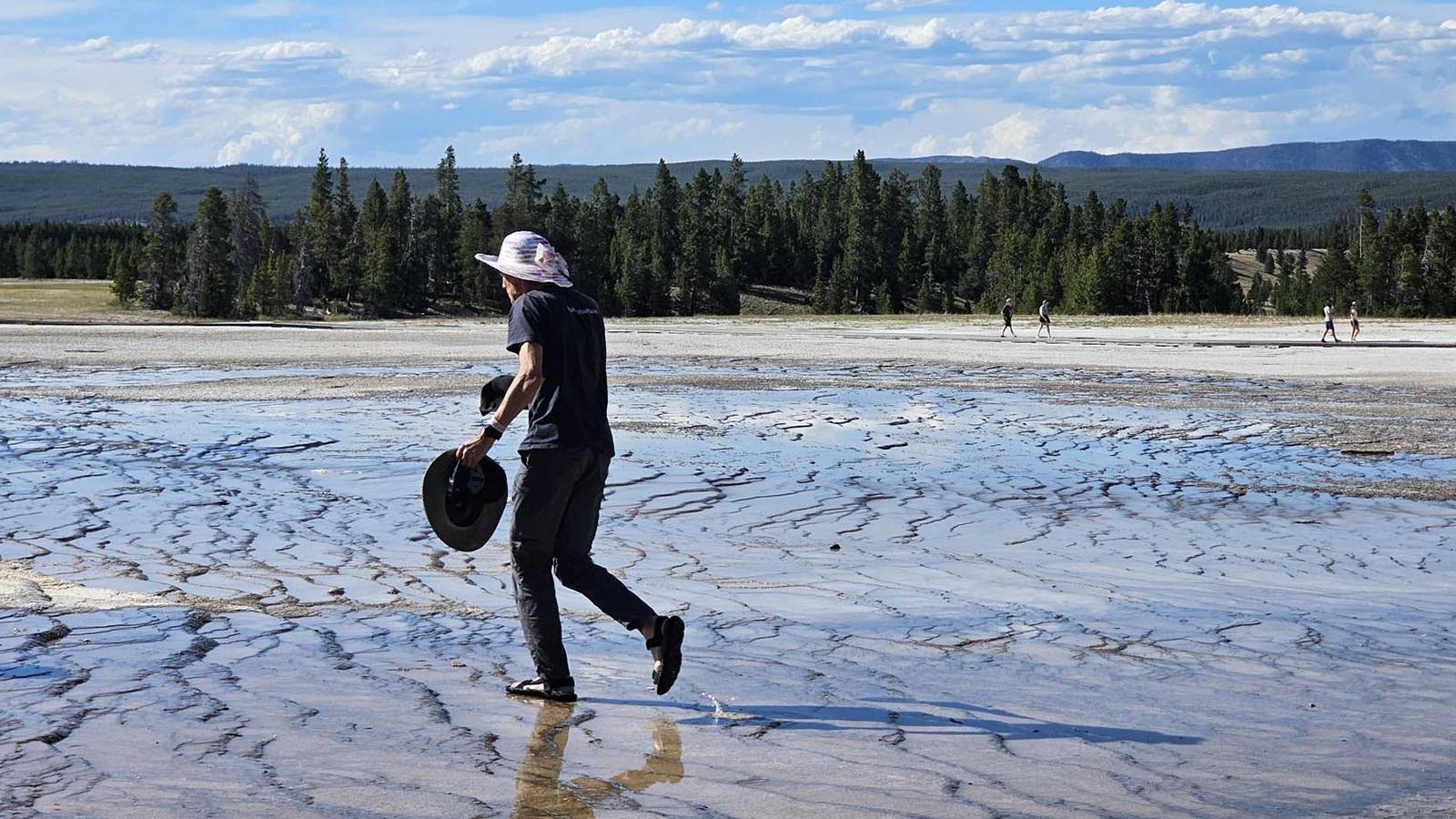 Other Yellowstone visitors were horrified Monday as they watched a man in flip-flops walking off the board walk onto the bacterial mats around Grand Prismatic Spring. He was picking up hats that had blown off people’s heads — and breaking the law.